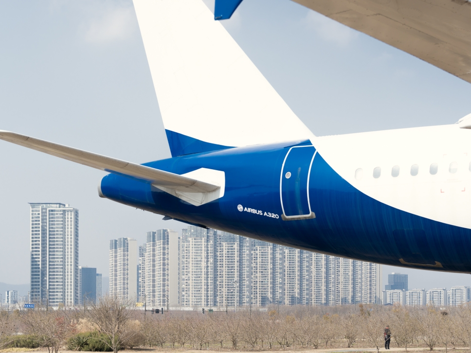 The tail of an airplane seen through a window