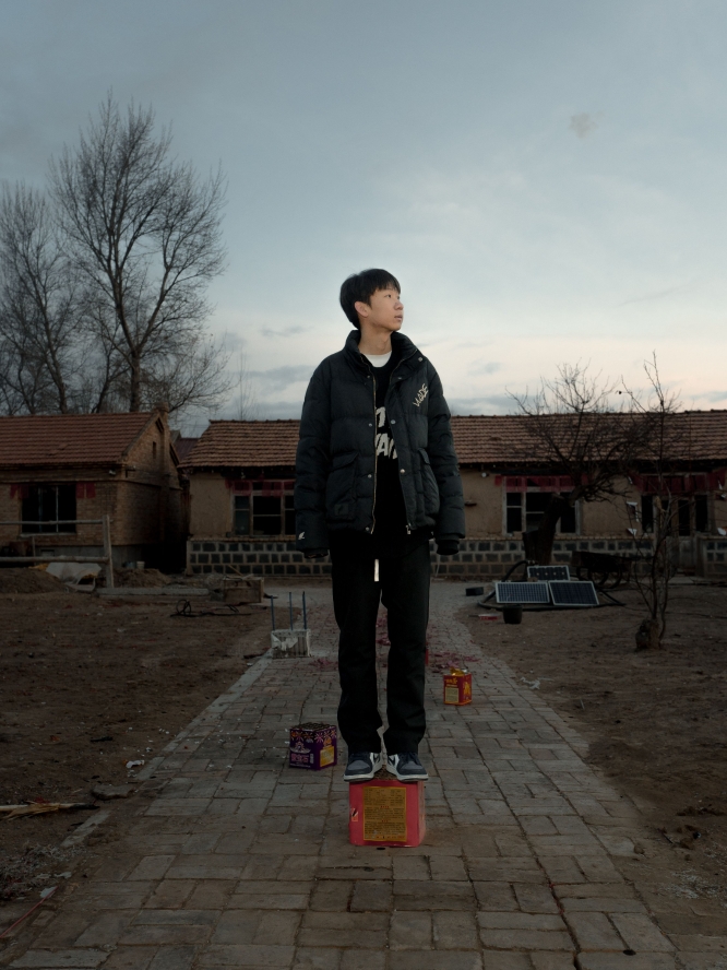 A person standing on stacked boxes